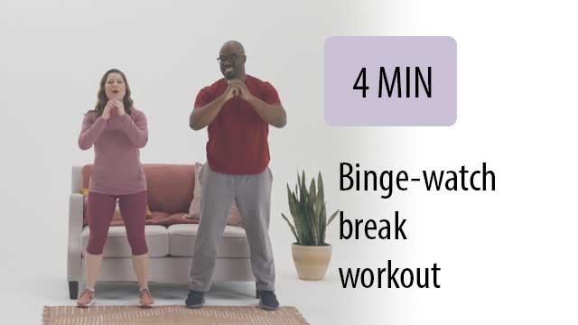 man and woman working out in front of couch