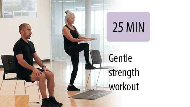 older instructor leading seated student in gym